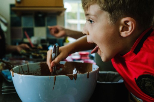 lifestyle vs documentary family photography - wild child eating cake batter