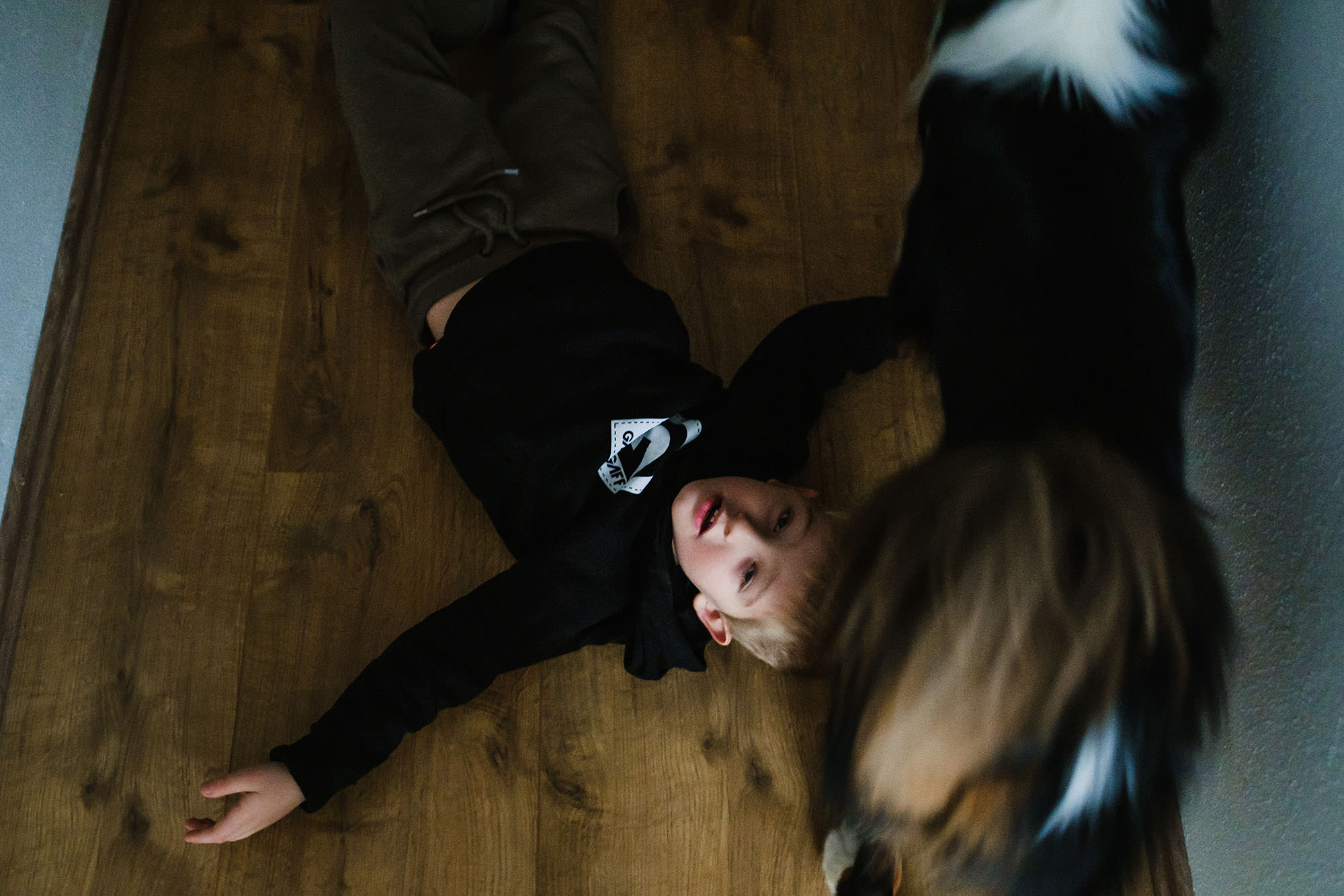 boy on the floor with his dog