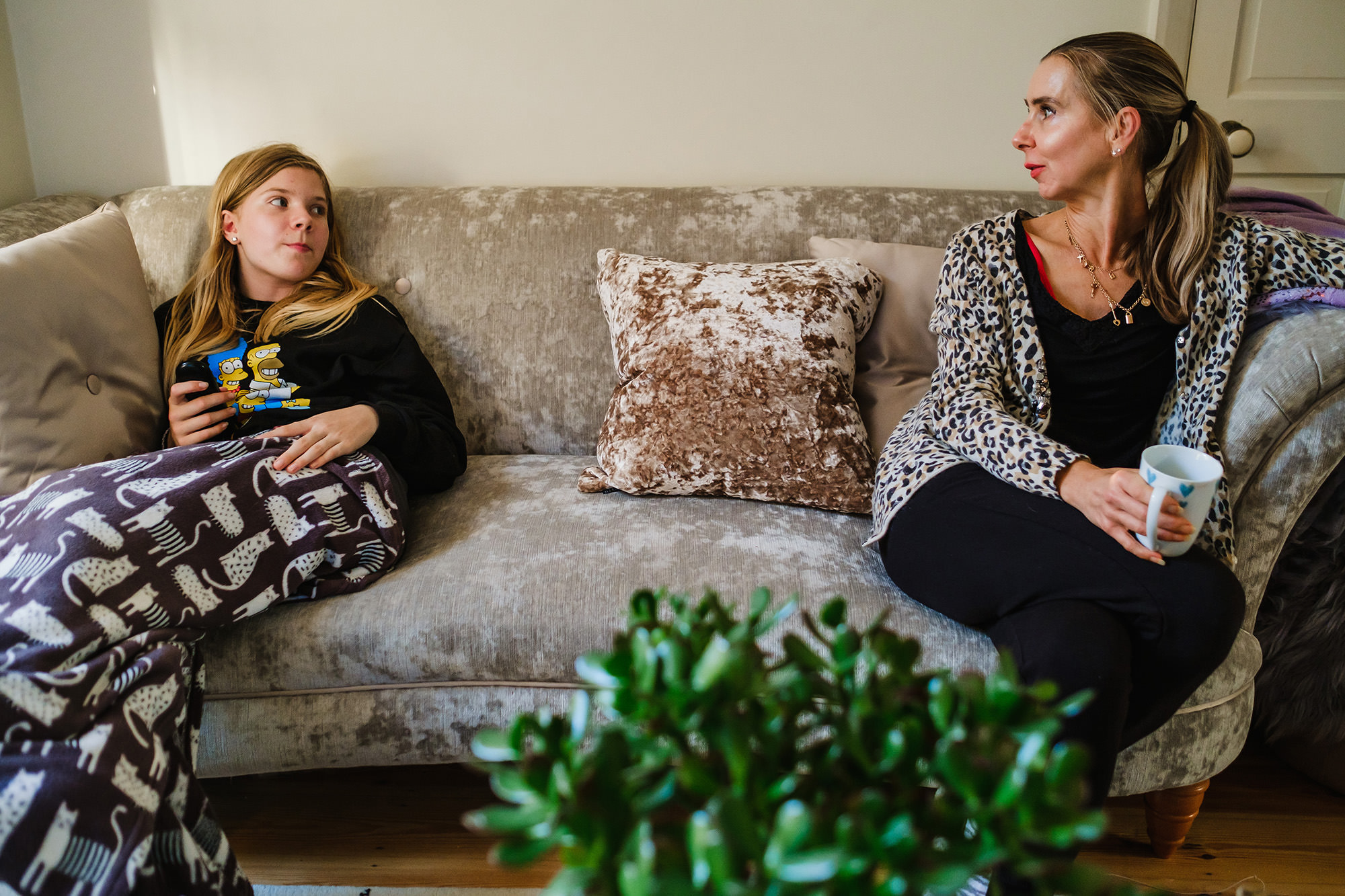 daughetr and mum cozy on couch