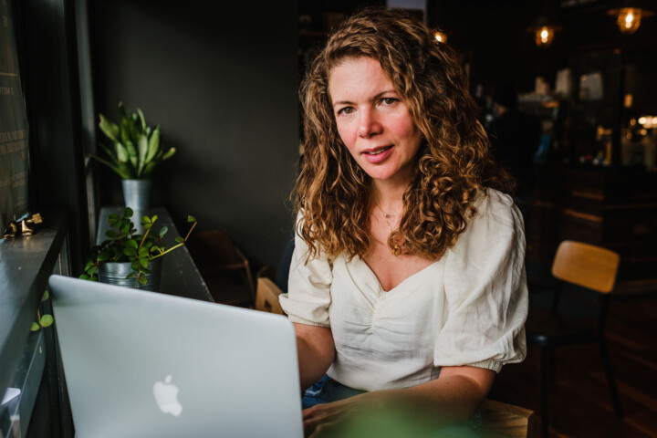 Lesley Stonier in coffee shop Hove working on laptop