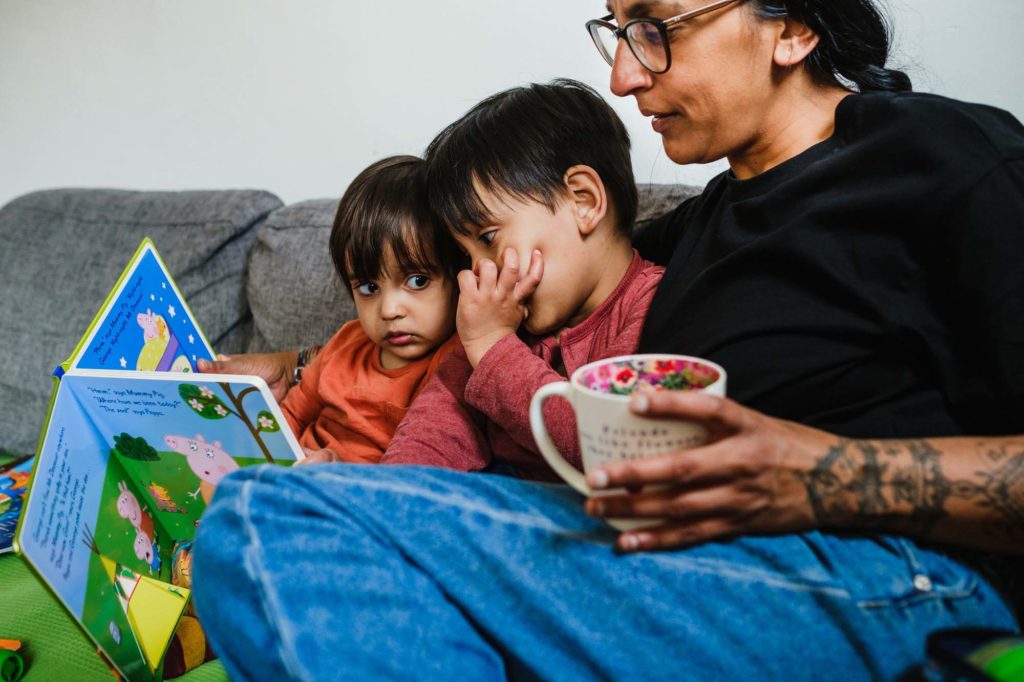 mum reading books with two kids