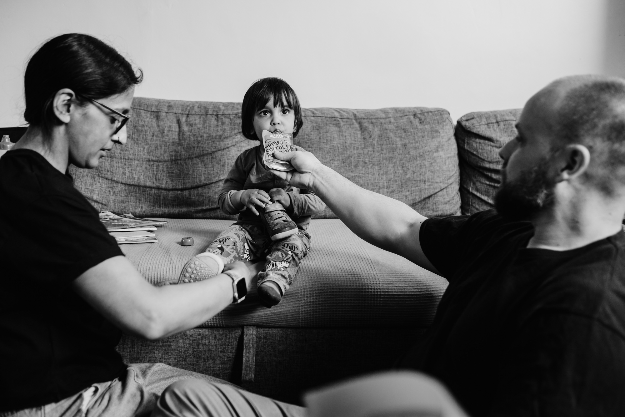 mum dad looking after toddler girl